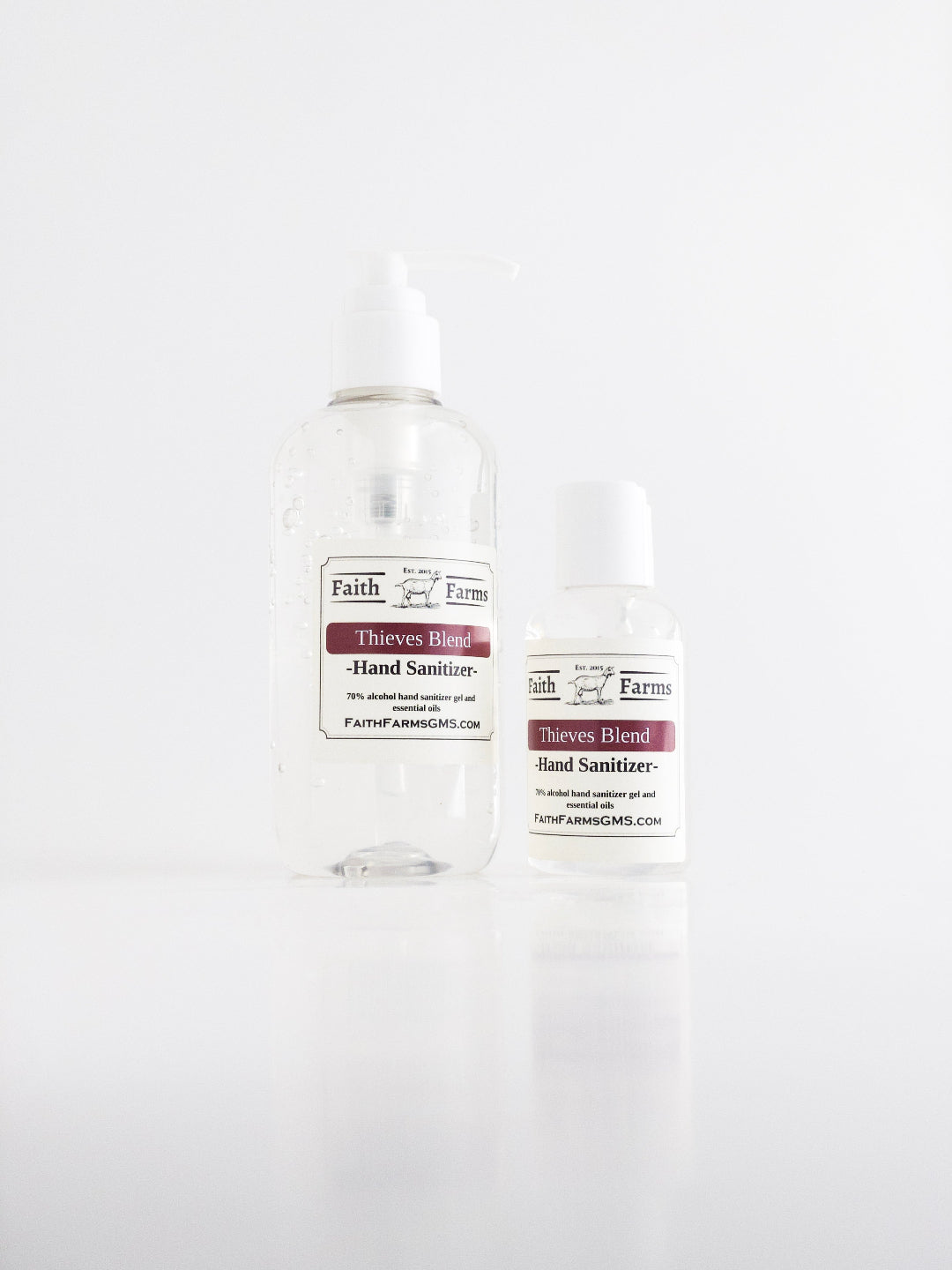 Two bottles of Faith Farms Thieves Blend hand sanitizer on a white background